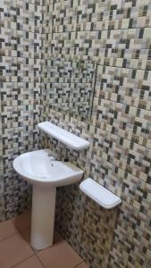 a bathroom with a sink and a toilet at Oluwa-Sheyi Apartment in Ketou in Kétou