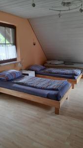 two beds sitting in a room with a window at Ferienwohnung in Horben mit Großem Garten - b48495 in Horben