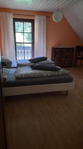 a bedroom with two beds and a large window at Ferienwohnung in Horben mit Großem Garten - b48495 in Horben