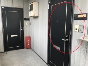 two black doors in a room with a red circle at AppleRoom高瀬駅近201 in Mitoyo