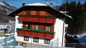 a small building with snow on the roof at Ferienwohnung für 8 Personen ca 95 qm in Pellizzano, Trentino Val di Sole in Pellizzano