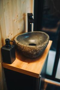 a stone bowl sitting on top of a wooden table at Včelín Müslivna in Jablonné v Podještědí