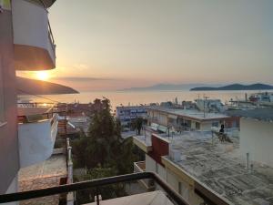 een balkon met uitzicht op de stad bij zonsondergang bij SEAgull apartments in Néa Péramos