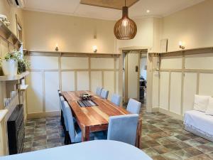 a dining room with a wooden table and blue chairs at D103 Lemon Tree House in Melbourne