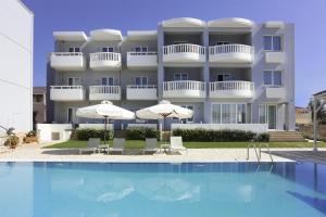 a hotel with a swimming pool in front of a building at Artina Nuovo in Marathopoli