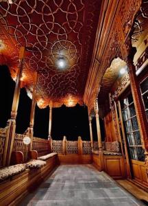 een grote kamer met een podium met een plafond bij Floating Luxury Group Of Houseboats in Srinagar
