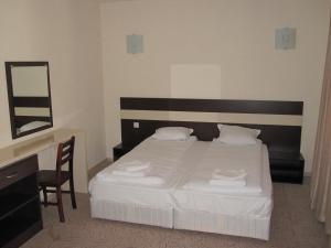 a bedroom with a bed and a desk and a mirror at Hotel Deyanira in Gorno Dryanovo +96 photos