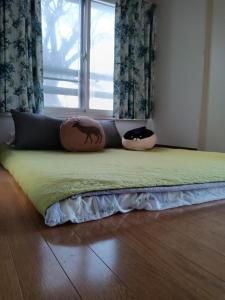 a bed with two pillows on it in a room at Tokyo downtown芍藥莊 in Tokyo
