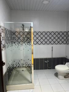 a bathroom with a shower and a toilet at سفانه in Unayzah
