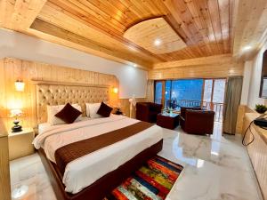 a bedroom with a large bed with a wooden ceiling at Pinerock hotel in Mussoorie