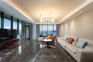 a living room with a couch and a tv at Holiday Inn Express Zhuhai Guishan Island, an IHG Hotel in Zhuhai