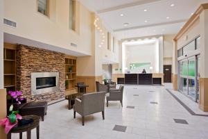 a lobby of a hospital with chairs and a fireplace at Holiday Inn Hotel & Suites Surrey East - Cloverdale, an IHG Hotel in Surrey