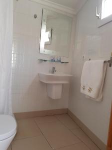 a white bathroom with a sink and a mirror at Hotel Maritimo in Alicante