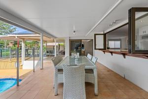 a dining room with a table and chairs at Serene Lakefront Villa with Private Pool 