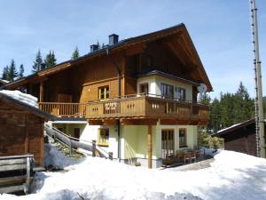 a house with a balcony on top of snow at Zillertalarena 148 in Krimml