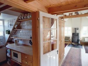 a kitchen with a cupboard and a stove at De Höller - Dakappartement met Toren 