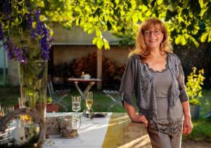 a woman standing next to a table in a garden at Pension EssLust in Niedergörsdorf +18 photos