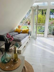 a living room with a couch and a table at Moderner Altbau mit Infrarotsauna im Grünen in Witten