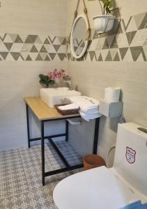 a bathroom with a sink and a toilet at Blue Sea House Quảng Bình - Căn hộ 2 phòng ngủ, phòng khách và phòng bếp in Dong Hoi