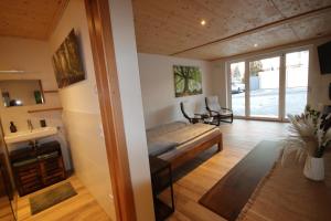 a room with a bed and a sink in it at Raichberg Appartements in Hechingen