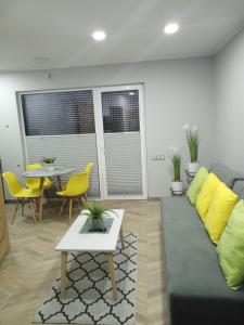 a living room with a couch and a table at Apartamenty Jana Pawła in Uniejow