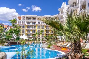 a hotel with a swimming pool in front of a building at Harmony Suites - Monte Carlo in Sunny Beach
