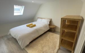 a bed with a teddy bear sitting on top of it at Spire attic apartment no kitchen in Dublin
