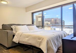 a bedroom with a bed and a large window at Modern 1Bdrm Oceanview with Parking in Honolulu