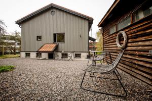 a metal chair sitting in front of a building at Vivante Basement Accommodation in Porvoo