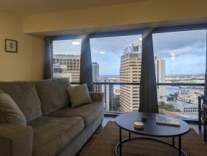 a living room with a couch and a table at Modern 1Bdrm Oceanview with Parking in Honolulu