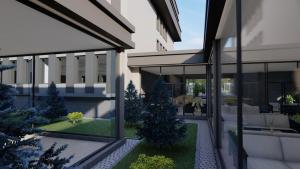 a rendering of a building with a courtyard with trees at GREAT SILK ROAD HOTEL in Fergana