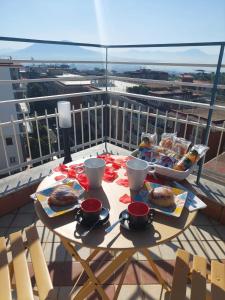 a table with food on top of a balcony at yo yo house luxury room in Naples
