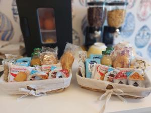 two baskets filled with food sitting on a counter at yo yo house luxury room in Naples