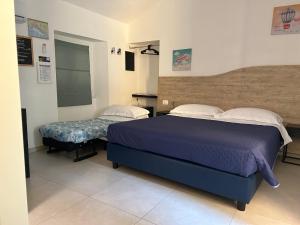 a bedroom with two beds in a room at Pink House Garden in Monterosso al Mare