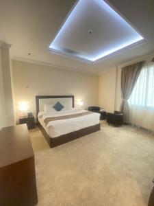 a large bedroom with a bed and a ceiling at A Line Hotel in Doha
