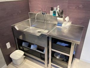 a stainless steel sink in a bathroom with a toilet at KiCHi - Vacation STAY 15503 in Awaji