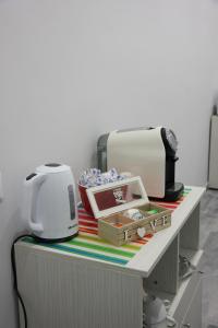 a counter with a toaster and other items on it at Dolce Titina Affittacamere in Rome