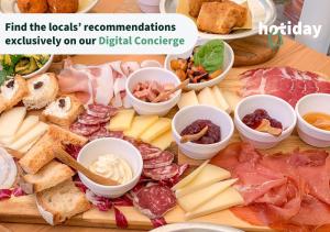 una tabella ricoperta di formaggio, carne e altri alimenti di HOTIDAY ApartHotel Firenze a Firenze