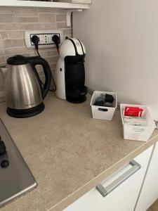 a kitchen counter with a coffee maker and a tea kettle at Casa Marina in Carloforte