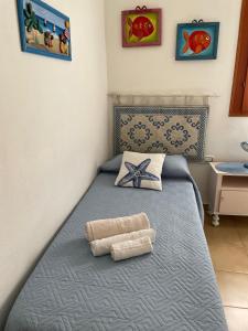 a bedroom with a bed with a towel on it at Casa Marina in Carloforte