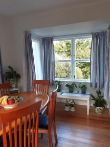 a dining room with a table and a window at Happy Space in Waihi