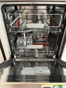 an open dishwasher with dishes in it at M. Szwed. Guest House old Bari in Bari