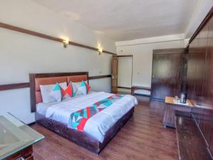 a bedroom with a large bed in a room at Hotel Karma in Amritsar