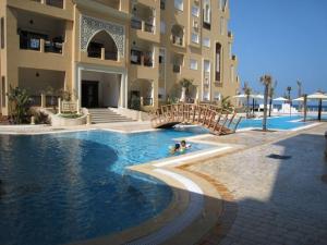 a swimming pool in front of a large building at Studio S0 FOLLA RESORT CHATT MERIEM in Sousse +19 photos