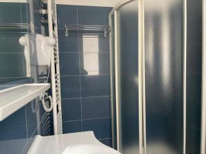 a bathroom with a toilet and a glass shower at CASA MAJOR Hotel & Appartamenti CERVIA in Cervia