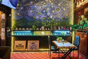 a bar with a table and a starry ceiling at Happiness Community Wake & Bake Hostel - Rooftop Bar & Bistro in Pattaya