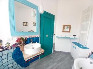 a bathroom with a blue door and a sink at Villa Mondello Terraces & Jacuzzi in Mondello