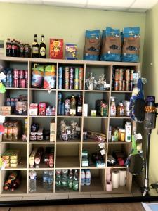 a shelf filled with lots of food and drinks at Mobilhome Baltique in Oye-Plage