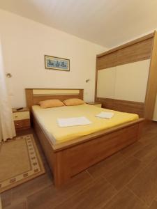a bedroom with a large bed in a room at Apartment Toni in Duće