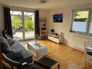 uma sala de estar com um sofá e uma mesa em Weideblick, traumhaft wohnen im Schwarzwald em St. Georgen
